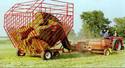 Steel framed wagon catching bales behind the tractor as they are made