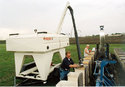 Man using Bulk Seed Wagon to fill seeder