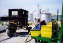 Man using Pneumatic Bulk Seed Conveyor to fill seeder