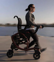 Woman walking in a half-standing position using the sit-stand walker as support